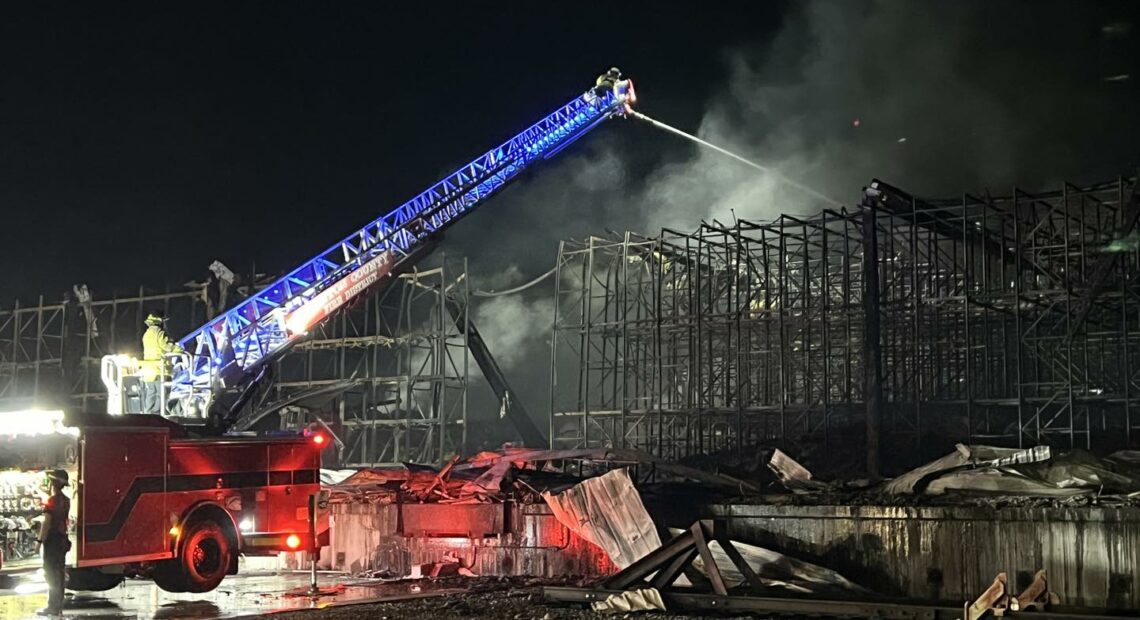 Fire crews spray water on rubble at the Lineage Logistics fire in Finley, Washington. The fire started on April 21. (Credit: Benton County Fire District 1)