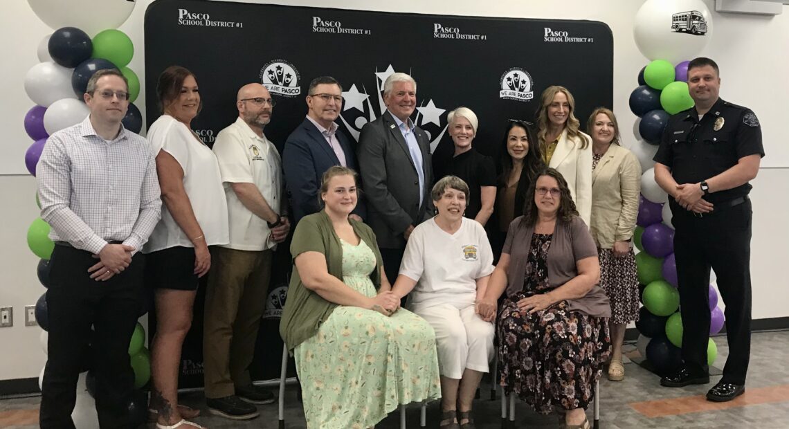 Group of people sitting for picture to celebrate the act passing.