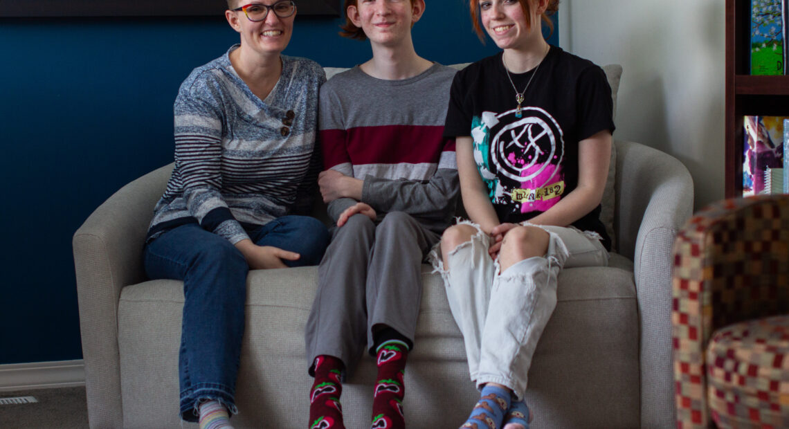 Jade Stellmon sits with her son, Hamilton Stellmon, and daughter, Tk, in their Moscow home on Friday. Hamilton Stellmon is currently taking a health class at Moscow High School where a guest speaker from the nonprofit Palouse Care Network was approved to provide guest lectures on sex ed. (Credit: Rachel Sun / NWPB)