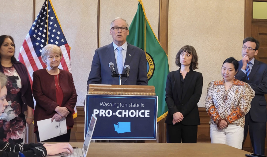 Washington Governor Jay Inslee speaks at a podium.