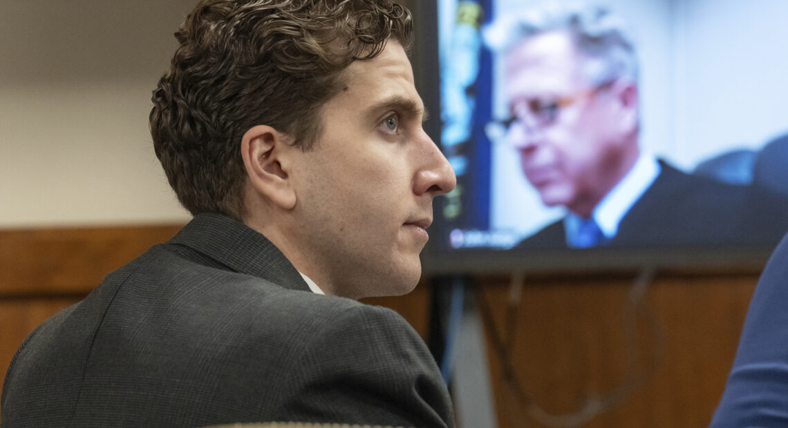 A photo shows the side profile of Bryan Kohberger, who has pale skin and dark hair. A video screen with the gray-haird Judge John Judge on display is in the background.