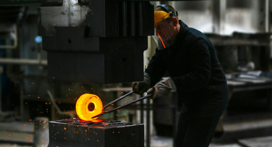 Man Lifting Hot Metal