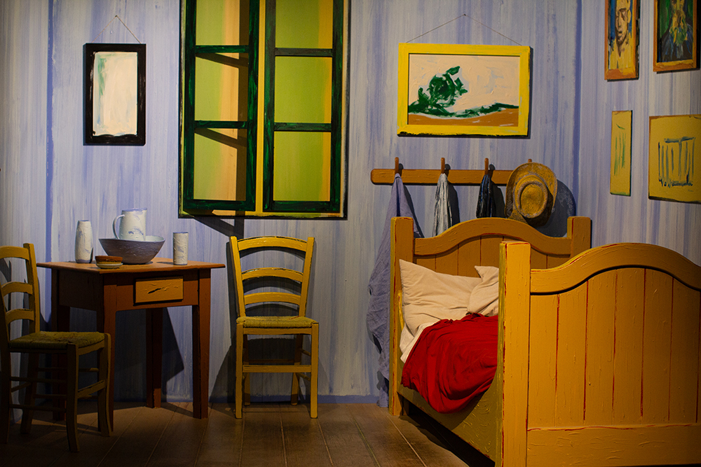 An interactive recreation of Vincent Van Gogh’s painting “The Bedroom” at "Van Gogh: The Immersive Experience" in Spokane. The recreation invites guests to sit inside the painting and take photos. (Credit: Rachel Sun / NWPB)