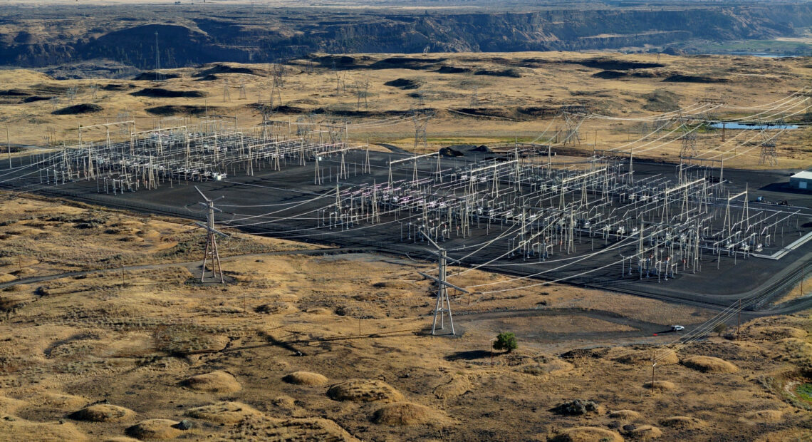 Large electrical transmission equipment is in a brown square. Shrub-steppe habitat surrounds the equipment.