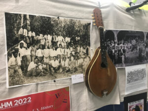 A traditional instrument and photographs are part of a historical exhibition of the Filipino community. (Credit: Johanna Bejarano/NWPB)