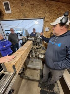 The wooden blocks that bees nest in are emptied by the one of a kind Bob Harvester machine. (Credit: Lauren Gallup / NWPB)