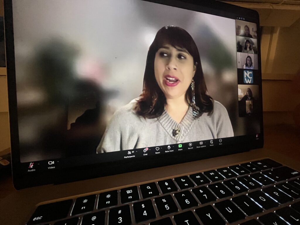 A woman talks on a Zoom call.