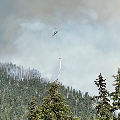 An aircraft drops water on the Easy Fire in Wenatchee in July.