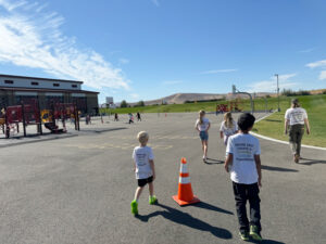 Students with the Kids for Urban Trees club walk around the playground at Tapteal Elementary School in West Richland. The playground doesn’t have much shade. (Credit: Courtney Flatt / NWPB)